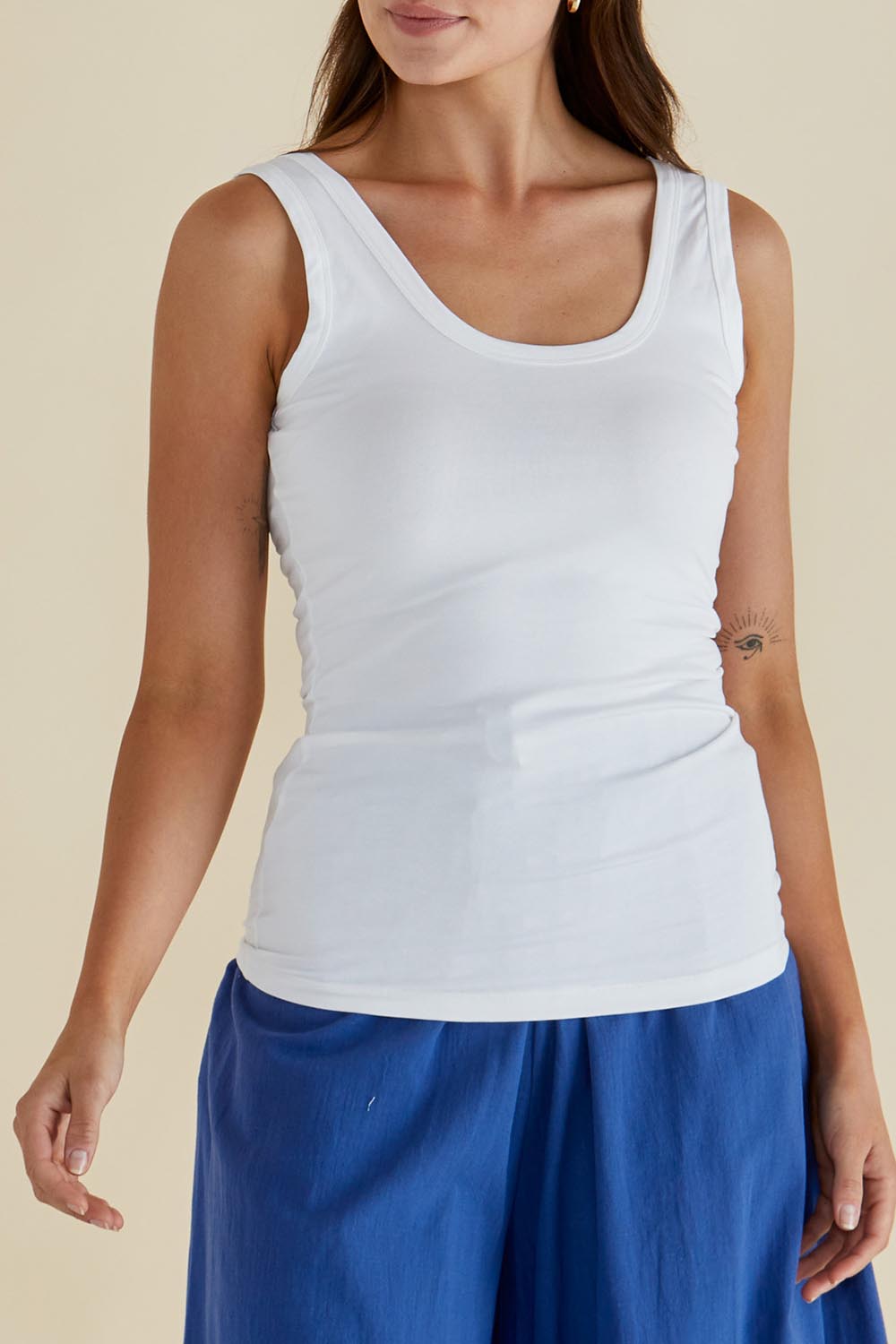 A model wearing the Emma Cotton Scoop Tank in colour White (White), from the front, cropped image