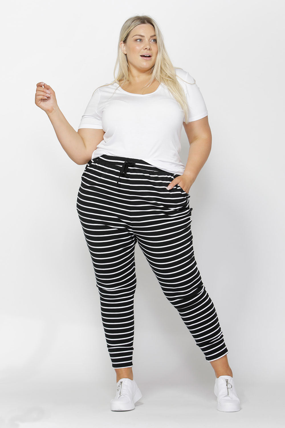 A model wearing the Jade Pant in colour BlackWhite (Black), from the front, showing the whole outfit