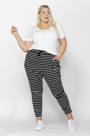 A model wearing the Jade Pant in colour BlackWhite (Black), from the front, showing the whole outfit