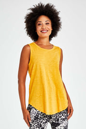 Model Olivia wearing size 10 of the Keira Tank in colour Mustard, from the front, cropped image
