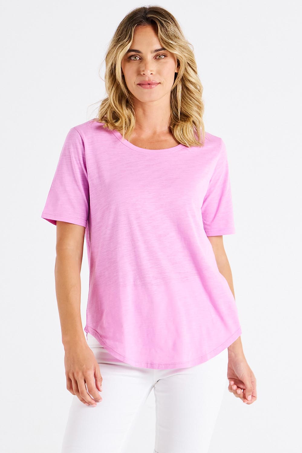 A model wearing the Ariana Cotton Tee in colour Vividberry (Pink), from the front, cropped image