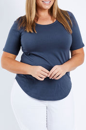 Model Fiona wearing size 16 of the Ariana Tee in colour Indiblue (Blue), from the front, cropped image
