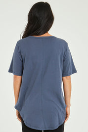 Model Katie wearing size 10 of the Ariana Tee in colour Indiblue (Blue), from the back