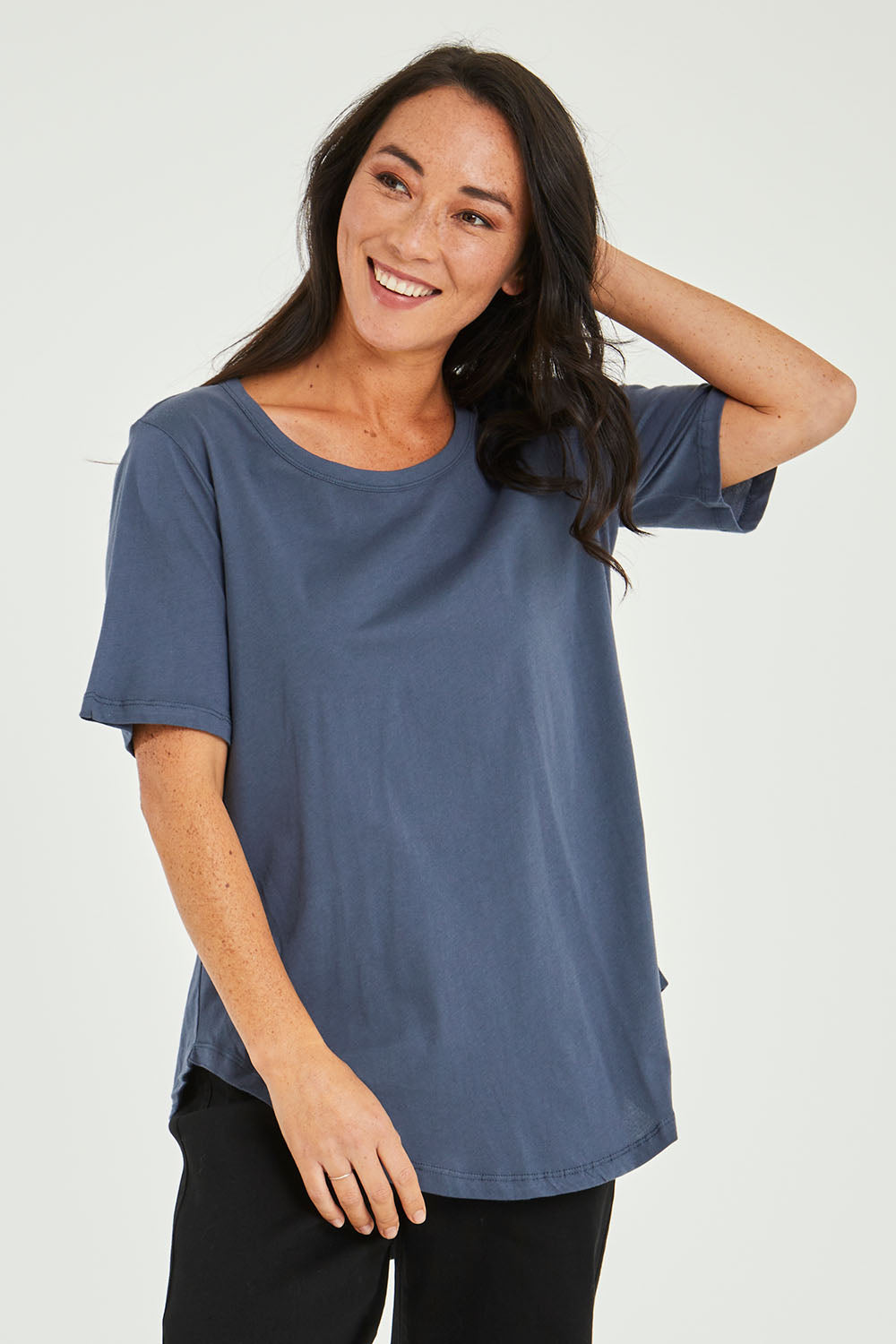 Model Katie wearing size 10 of the Ariana Tee in colour Indiblue (Blue), from the front, cropped image