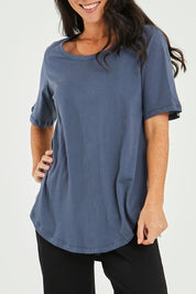 Model Katie wearing size 10 of the Ariana Tee in colour Indiblue (Blue), from the front, cropped image