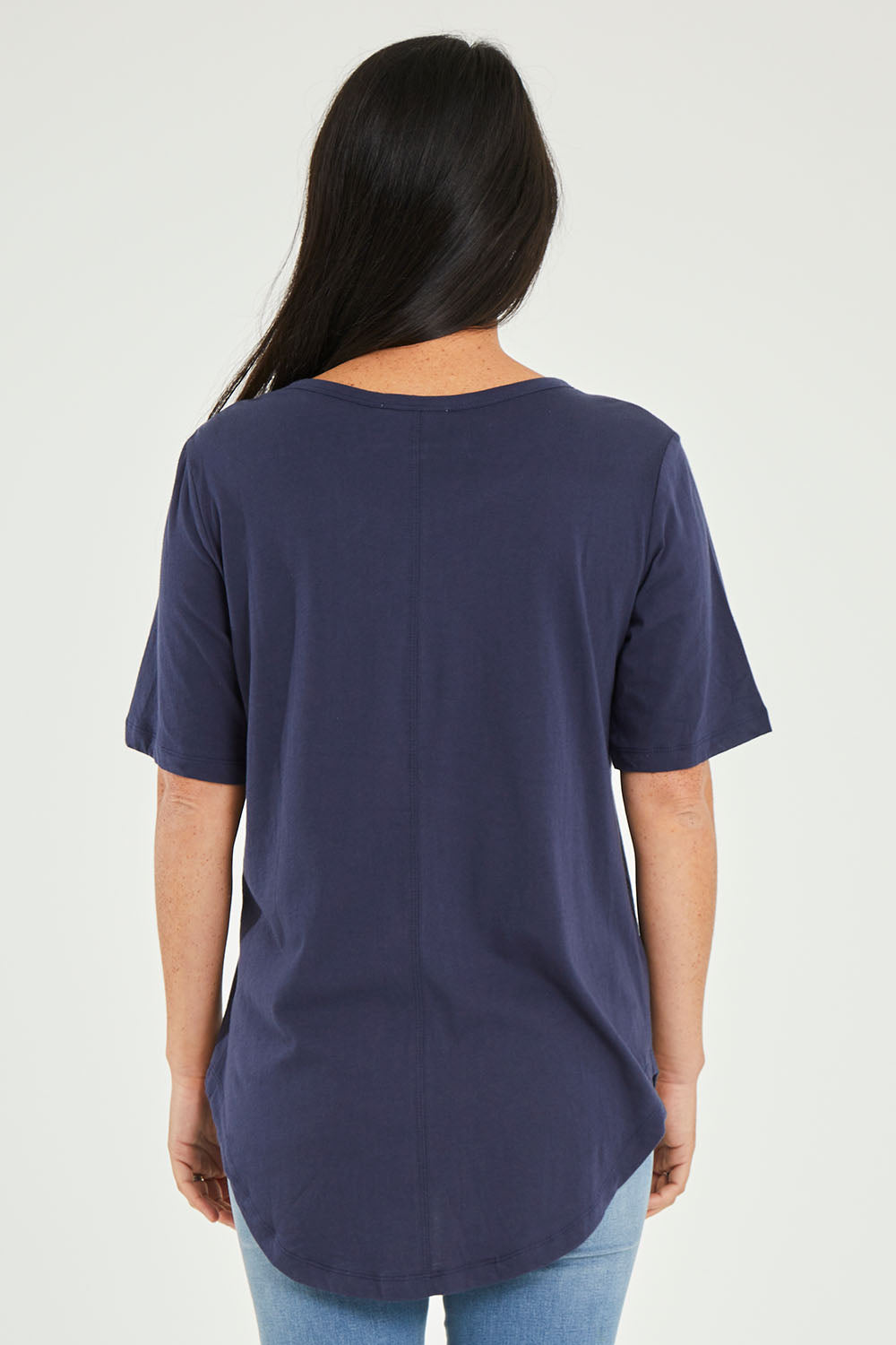 Model Katie wearing size 10 of the Ariana Tee in colour Newnavy (Blue), from the back