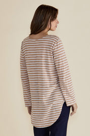 A model wearing the Megan Long Sleeve Top in colour Beigestrip, from the back