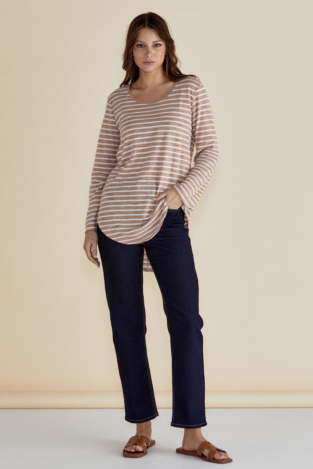 A model wearing the Megan Long Sleeve Top in colour Beigestrip, from the front, showing the whole outfit