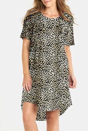A model wearing the Nyree Cotton Dress in colour Leopard, from the front, cropped image