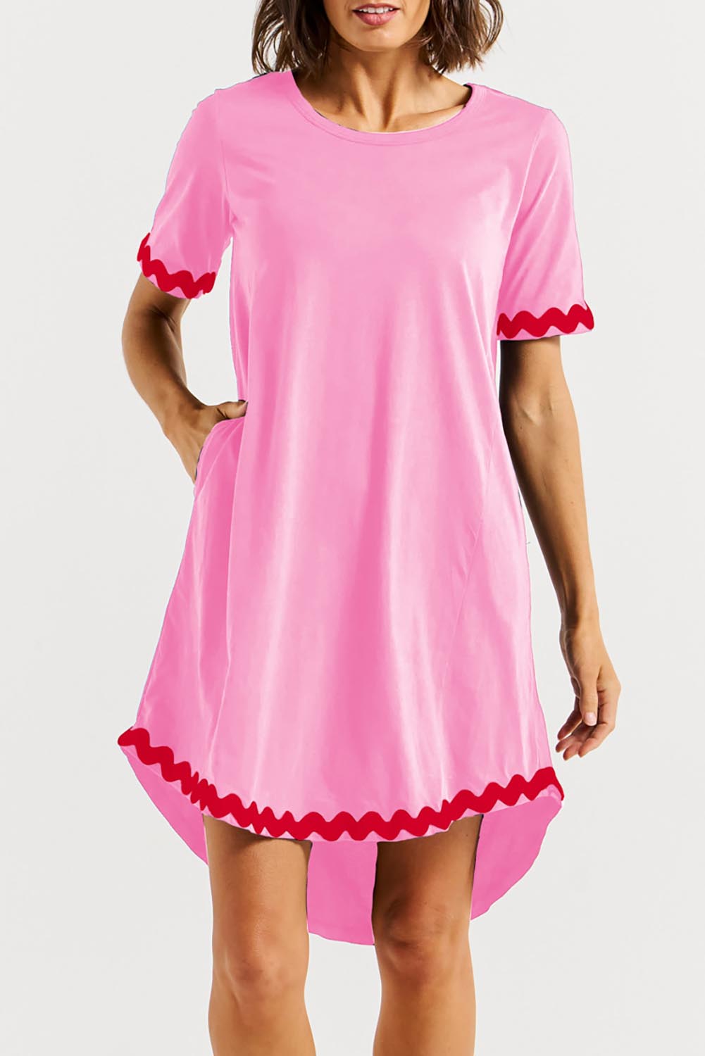 A model wearing the Nyree Cotton Dress in colour Redpinkric (Pink), from the front, cropped image