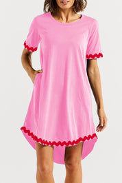 A model wearing the Nyree Cotton Dress in colour Redpinkric (Pink), from the front, cropped image