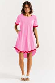 A model wearing the Nyree Cotton Dress in colour Redpinkric (Pink), from the front, showing the whole outfit