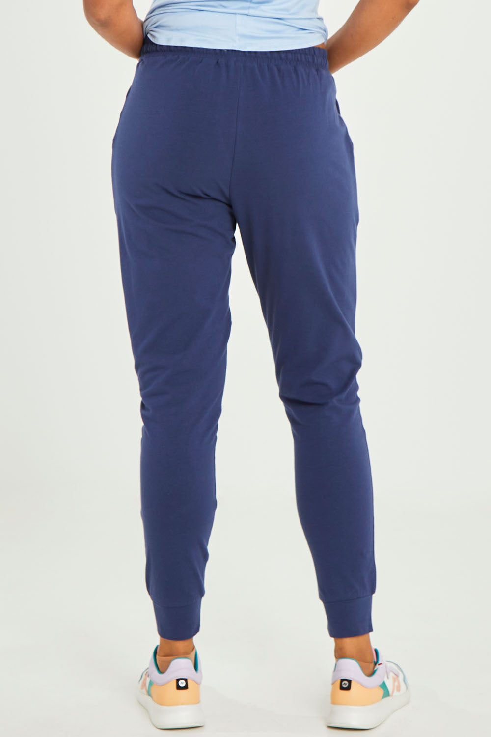 Model Olivia wearing size 10 of the Heidi Pant in colour Navy (Blue), from the back