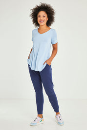 Model Olivia wearing size 10 of the Heidi Pant in colour Navy (Blue), from the front, showing the whole outfit