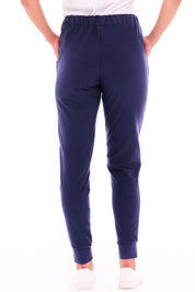 A model wearing the Heidi Pant in colour Navy (Blue), from the back