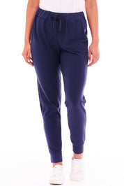 A model wearing the Heidi Pant in colour Navy (Blue), from the front, cropped image