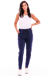 A model wearing the Heidi Pant in colour Navy (Blue), from the front, showing the whole outfit