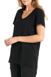 A model wearing the Billie Tee in colour Black (Black), from the front, cropped image