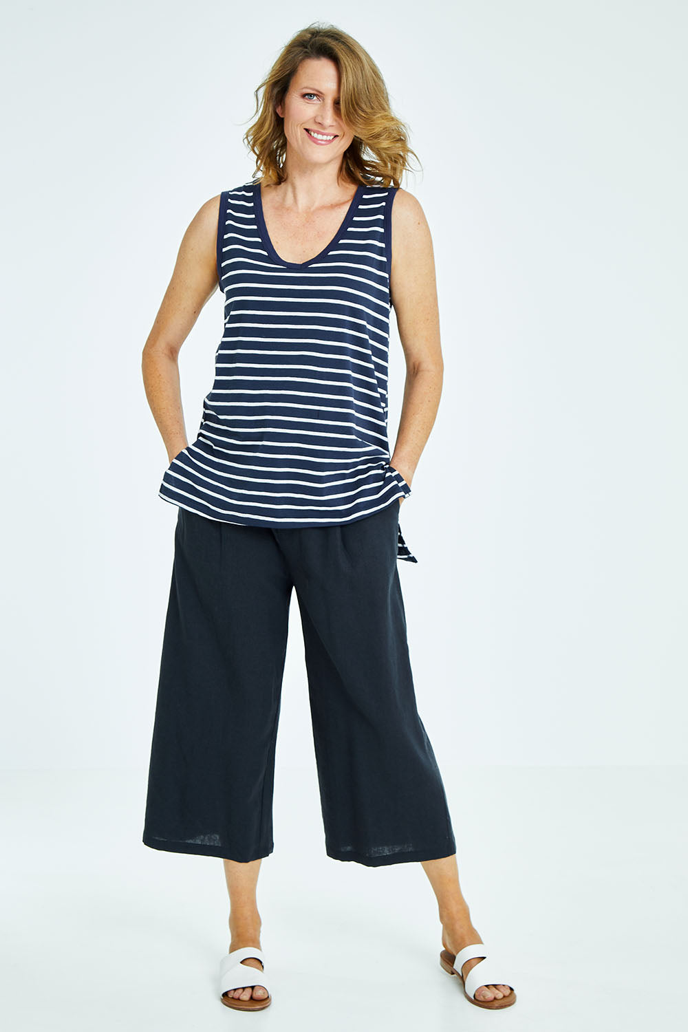Model Naomi wearing size 10 of the Audrey Tank in colour Nautical (Blue), from the front, showing the whole outfit