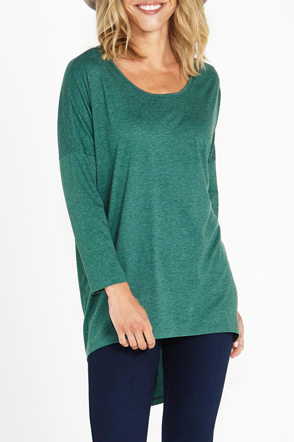 A model wearing the Celeste Tunic Tee in colour Greenmarle (Green), from the front, cropped image