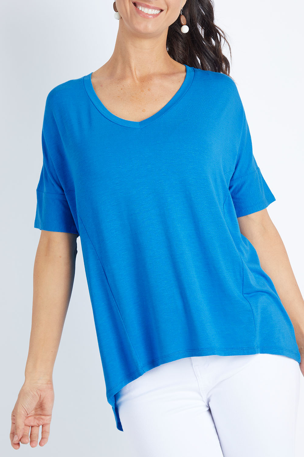 Model Gemma wearing size 10 of the Lisbon Tee in colour Cornflower (Blue), from the front, cropped image