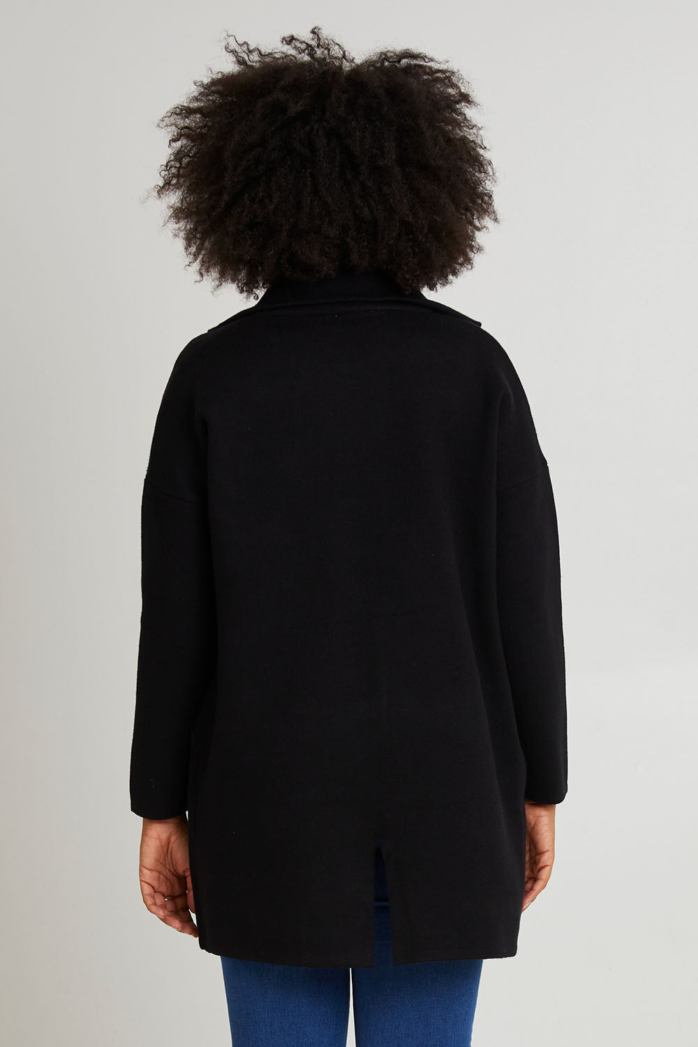 Model Olivia wearing size 10 of the Bristol Coatigan in colour Black (Black), from the back