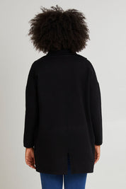 Model Olivia wearing size 10 of the Bristol Coatigan in colour Black (Black), from the back