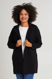 Model Olivia wearing size 10 of the Bristol Coatigan in colour Black (Black), from the front, cropped image