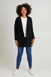 Model Olivia wearing size 10 of the Bristol Coatigan in colour Black (Black), from the front, showing the whole outfit