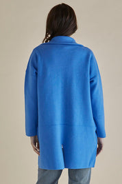 A model wearing the Bristol Coatigan in colour Blue (Blue), from the back