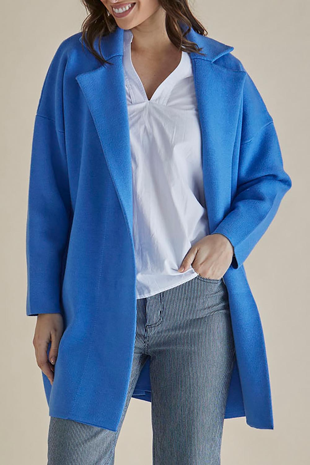 A model wearing the Bristol Coatigan in colour Blue (Blue), from the front, cropped image