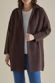 A model wearing the Bristol Coatigan in colour Brown, from the front, cropped image
