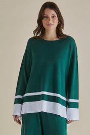 A model wearing the Eleanor Knit Jumper in colour Basil (Green), from the front, cropped image
