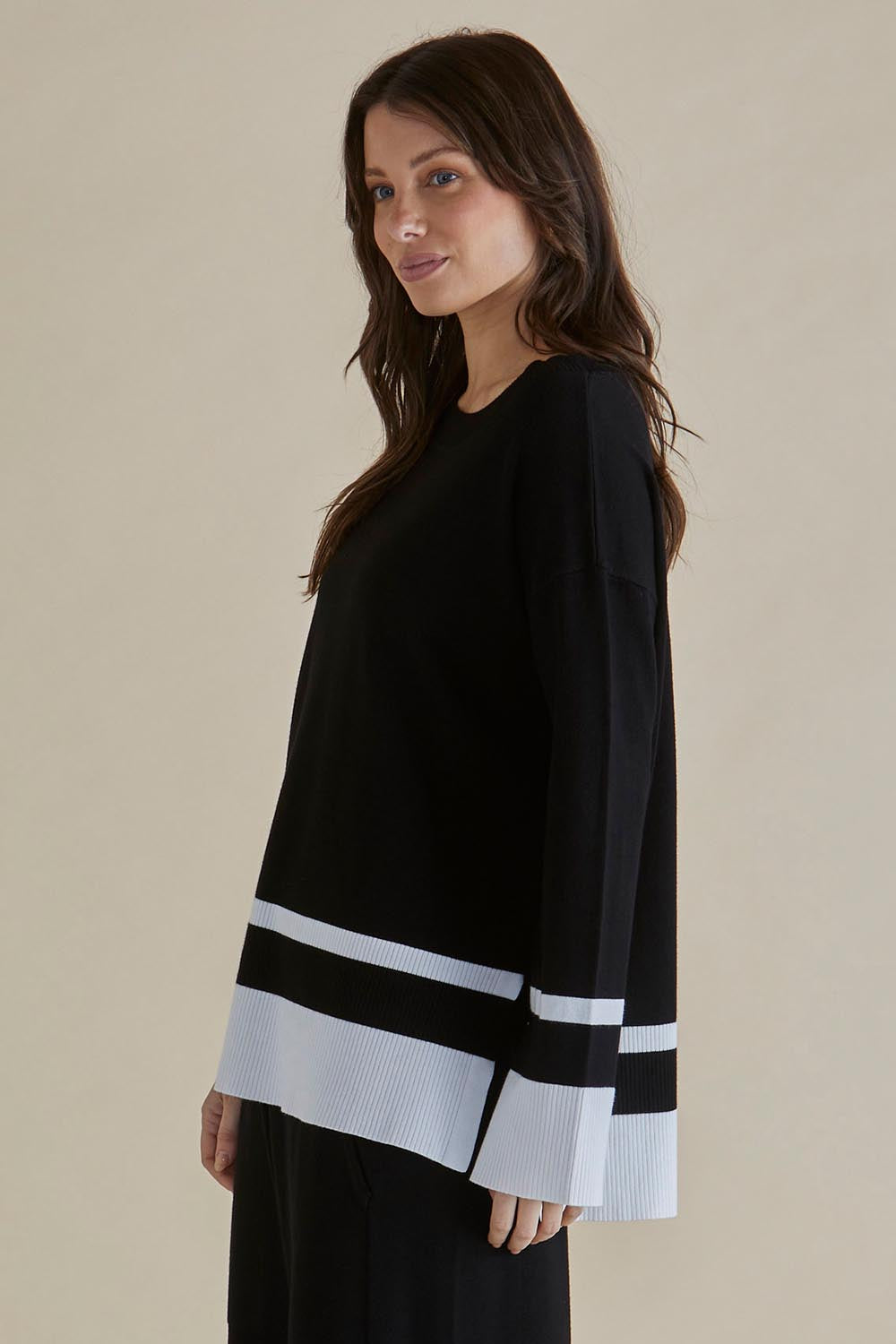 A model wearing the Eleanor Knit Jumper in colour Black (Black), from the front, cropped image