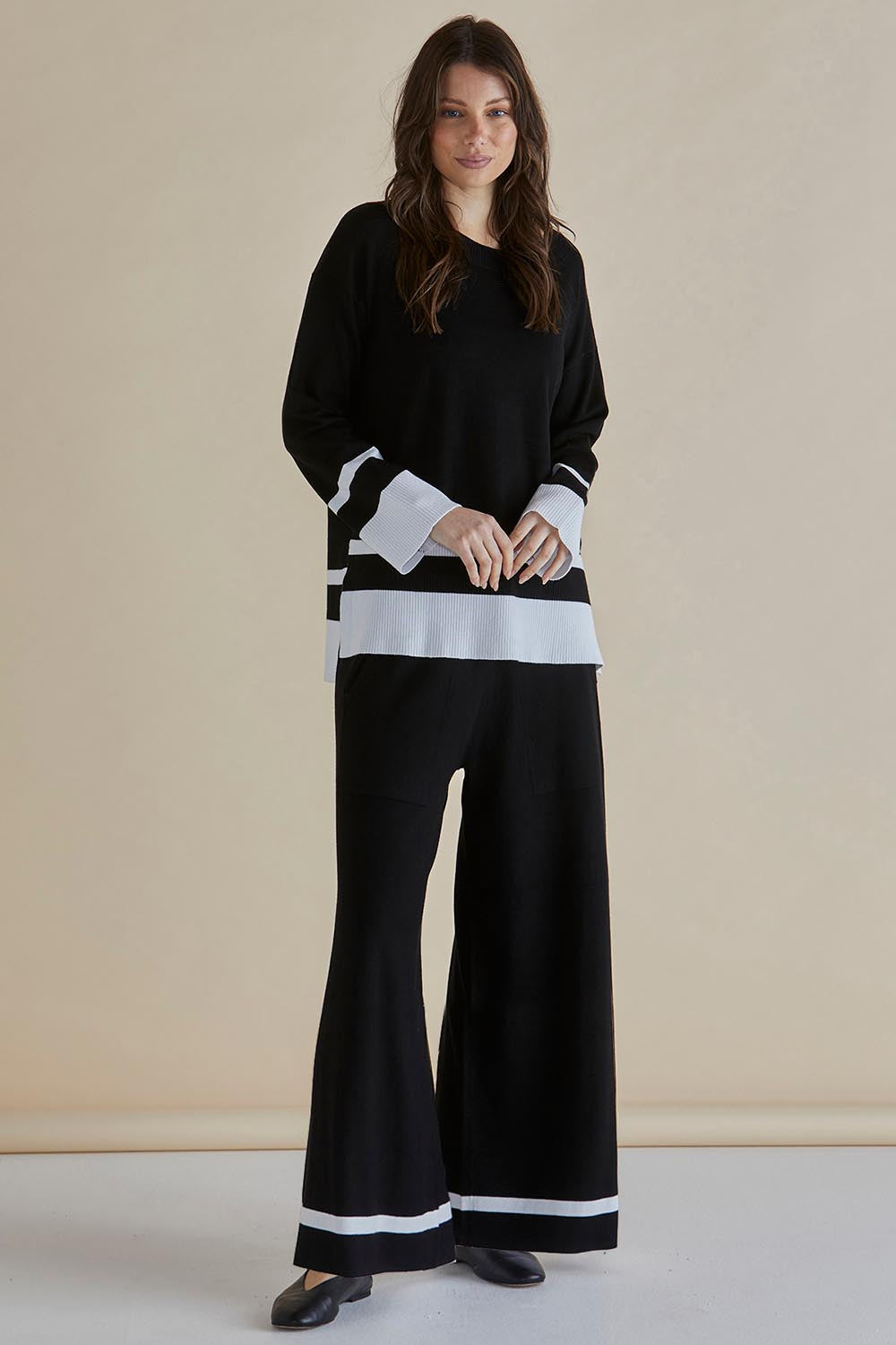 A model wearing the Eleanor Knit Jumper in colour Black (Black), from the front, showing the whole outfit