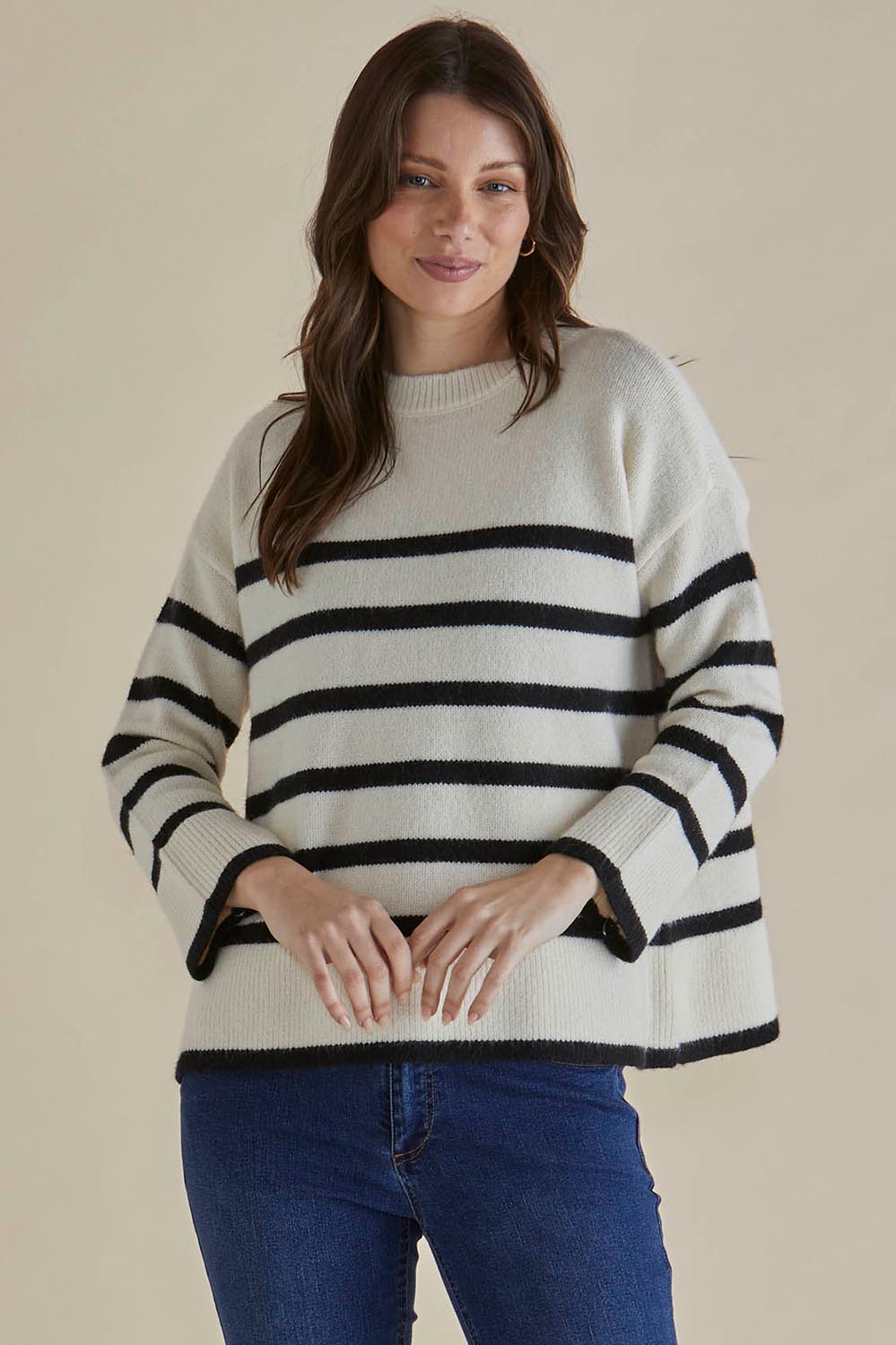 A model wearing the Edith Knit Jumper in colour Blkstripe (White), from the front, cropped image
