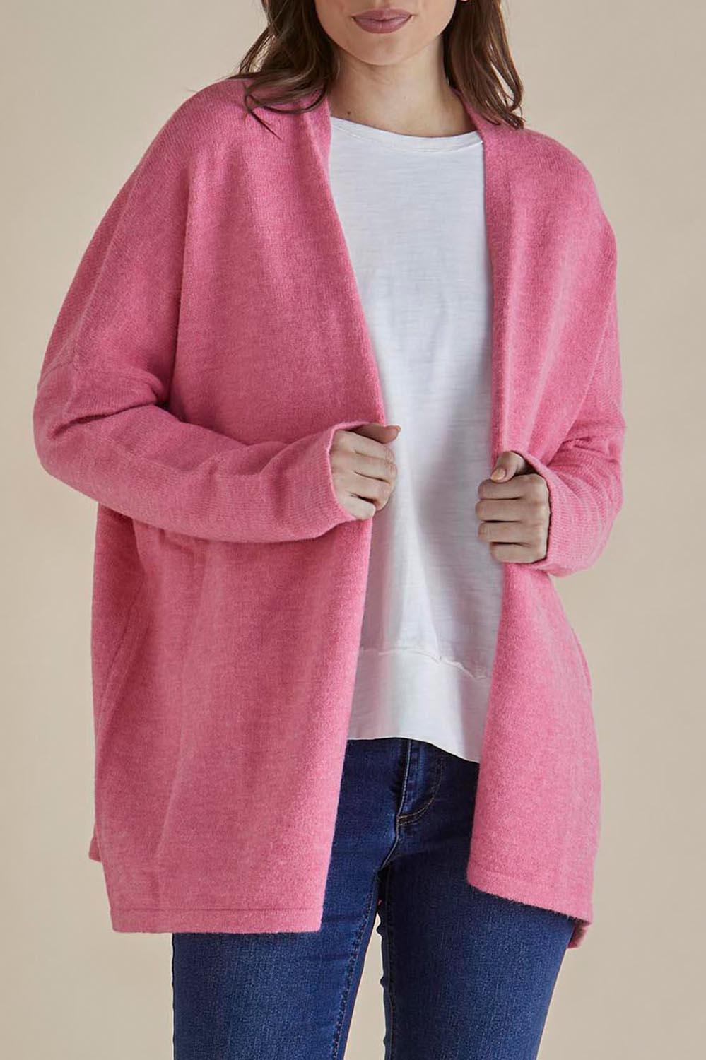 A model wearing the Emy Cardigan in colour Peonypink (Pink), from the front, cropped image