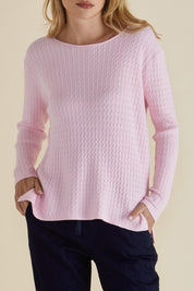 A model wearing the Cable Mini Jumper in colour Babypink (Pink), from the front, cropped image
