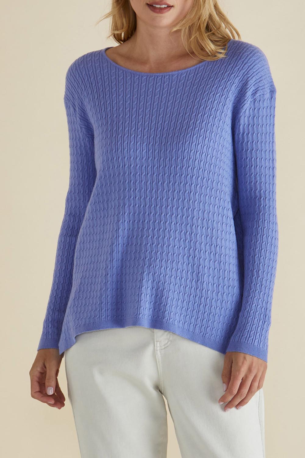 A model wearing the Cable Mini Jumper in colour Powderblue (Blue), from the front, cropped image