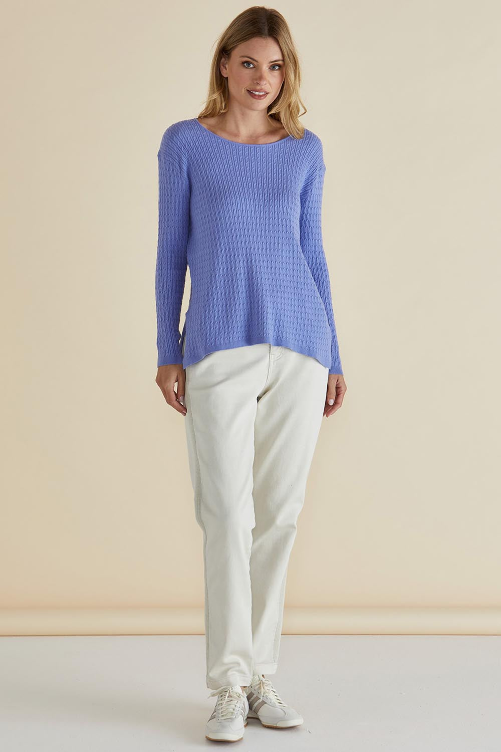 A model wearing the Cable Mini Jumper in colour Powderblue (Blue), from the front, showing the whole outfit