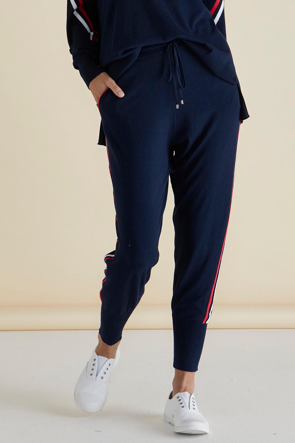 A model wearing the Aida Knit Pant in colour Navy (Blue), from the front, cropped image