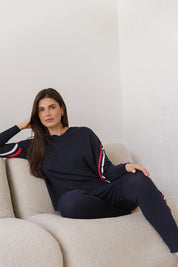 A model wearing the Aida Knit Pant in colour Navy (Blue), from the front, showing the whole outfit