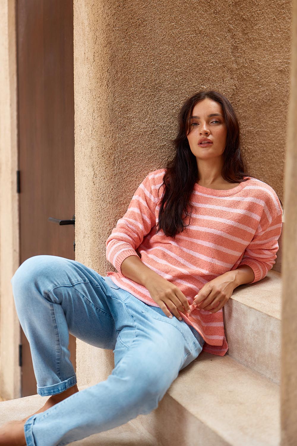 A model wearing the Bradford Knit Top in colour Coralpink (Pink), from the front, cropped image