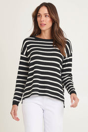 Model Madeline wearing size 10 of the Bradford Knit Top in colour Creamblk (Black), from the front, cropped image