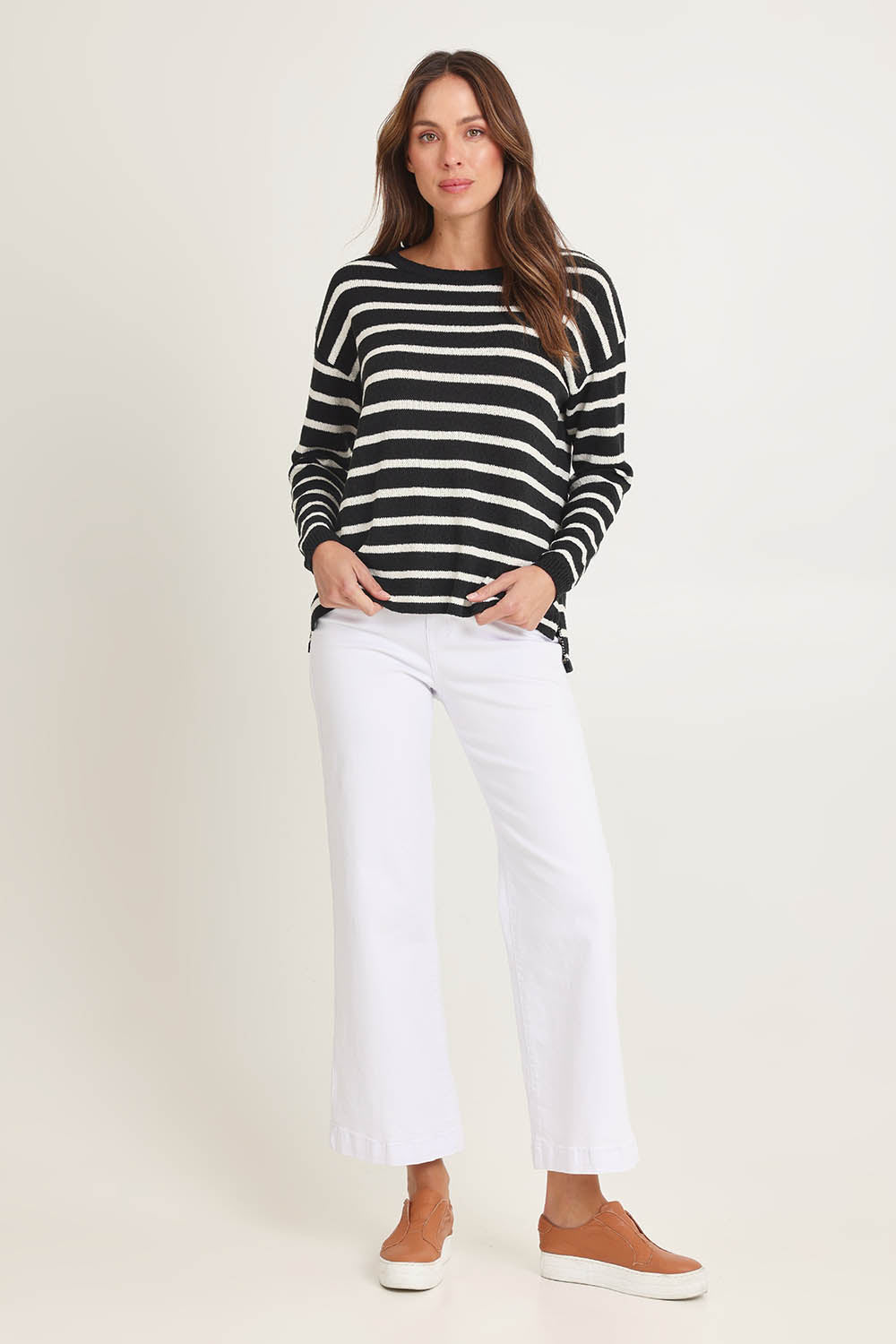 Model Madeline wearing size 10 of the Bradford Knit Top in colour Creamblk (Black), from the front, showing the whole outfit