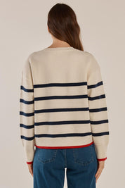 A model wearing the Leonie Knit Sweater in colour Navywhite (White), from the back