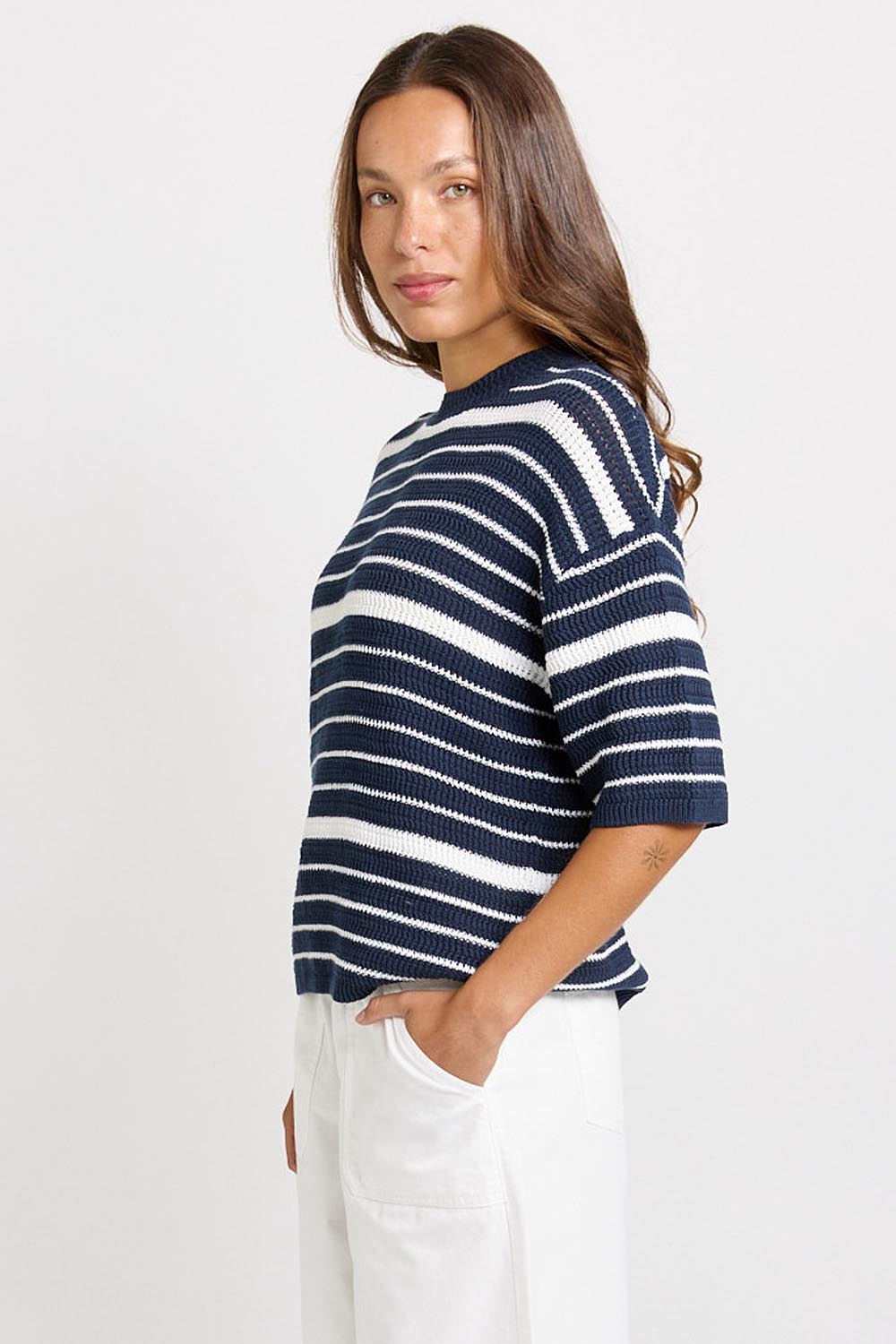 Model Genericm wearing size sample of the Dylan Knit Tee – Navywhite in colour Navywhite, from an angle