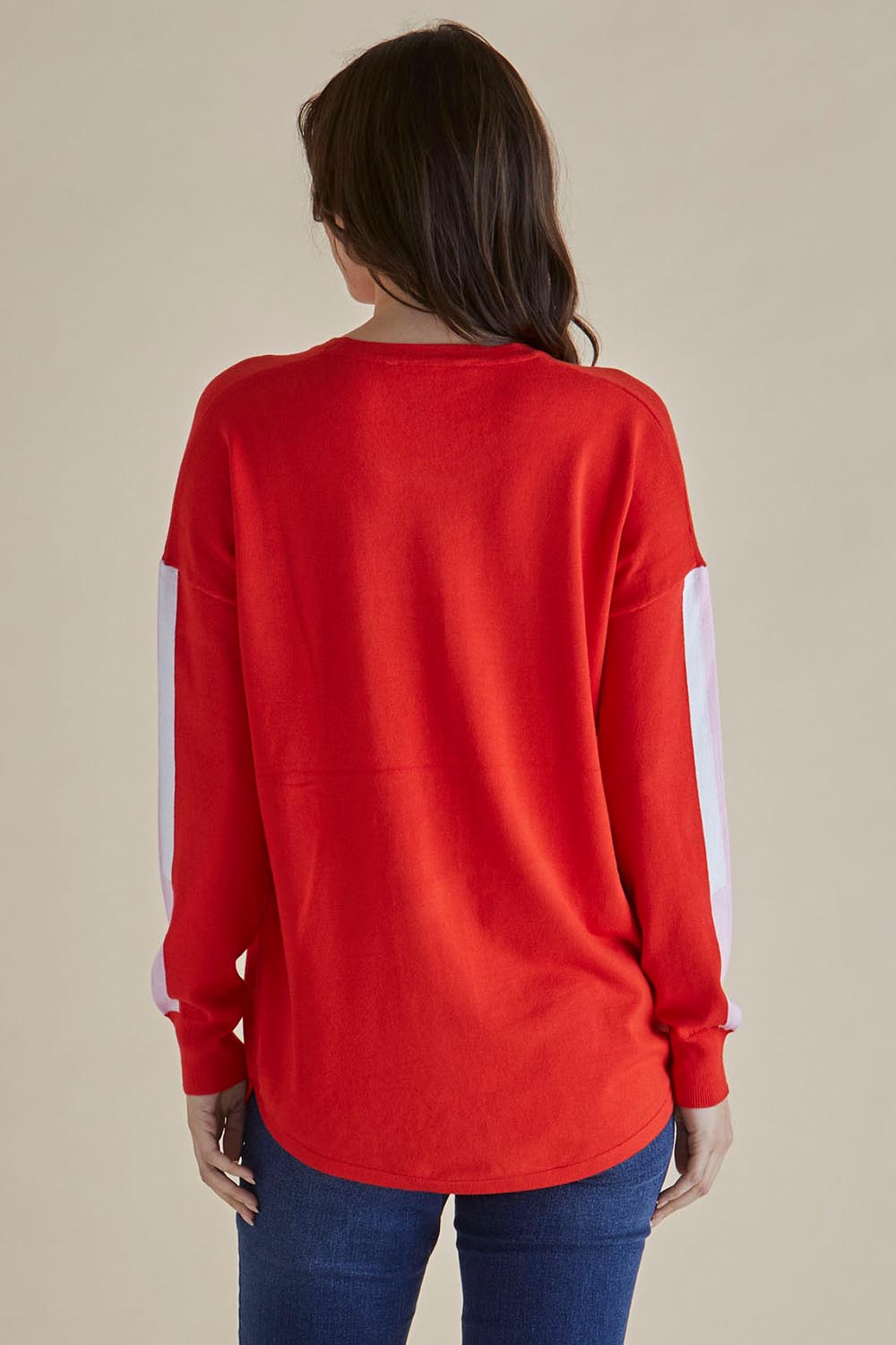 A model wearing the Sophie Knit Jumper in colour Red (Red), from the back