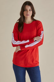 A model wearing the Sophie Knit Jumper in colour Red (Red), from the front, cropped image
