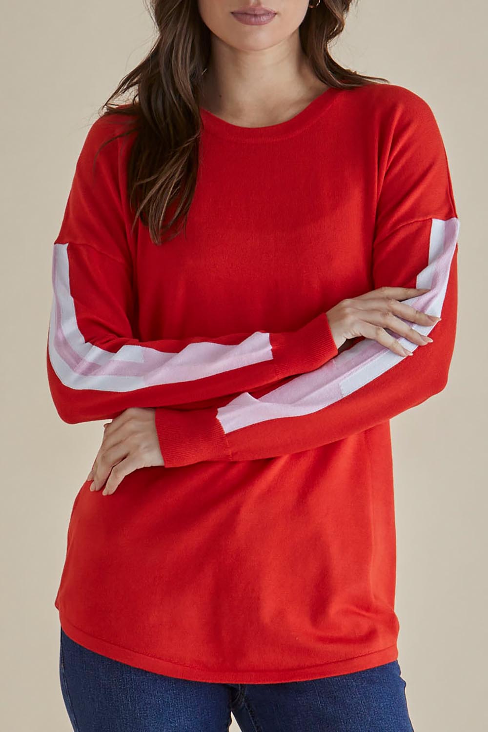 A model wearing the Sophie Knit Jumper in colour Red (Red), from the front, cropped image